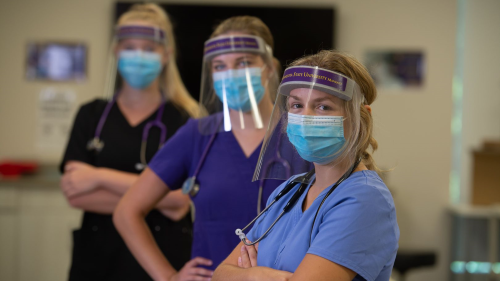 nursing students posing with branded face shields and masks