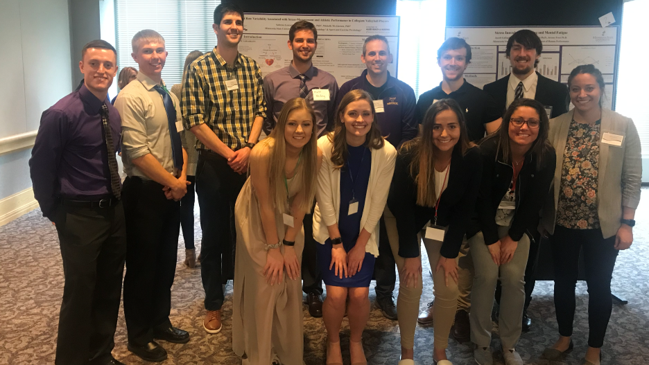 Eleven students of Exercise Science program with Dr. Jeremy Frost at an event