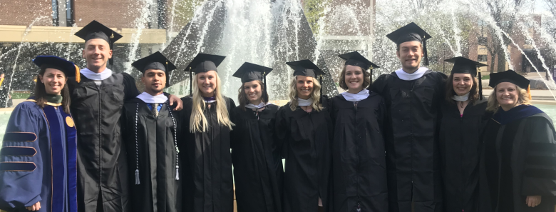a group of women in graduation gowns and caps