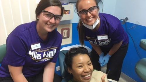 Students posing with smiles in the dental hygiene clinic for the 2022 Miles for Smiles 