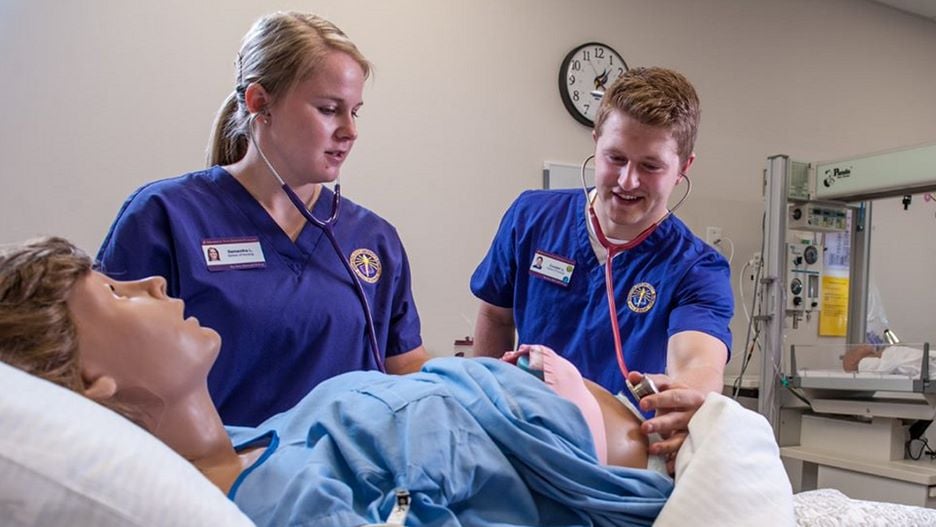 Two nursing students working on a simulation in the Maverick Family Nursing Simulation Center