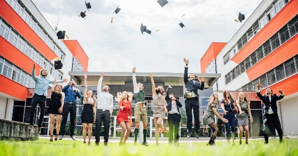 a group of people throwing graduation caps in the air