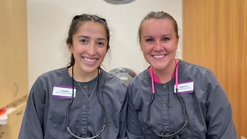 Lissette Garza and Kaitlyn Knutson in scrubs at dental clinic 