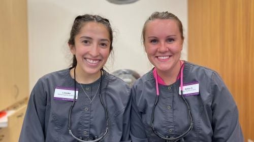 Lissette Garza and Kaitlyn Knutson posing in scrubs at dental clinic