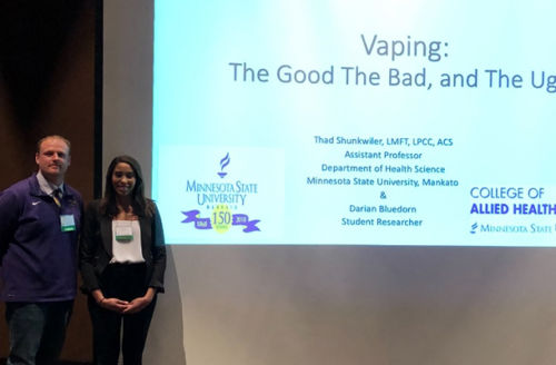 Thad Shunkwiler and Darian Bluedorn posing on stage for a lecture on vaping
