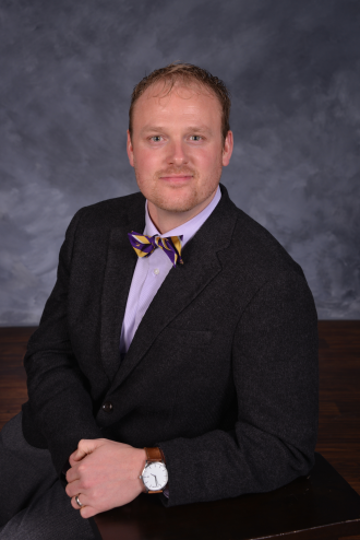 a person in a suit and bow tie