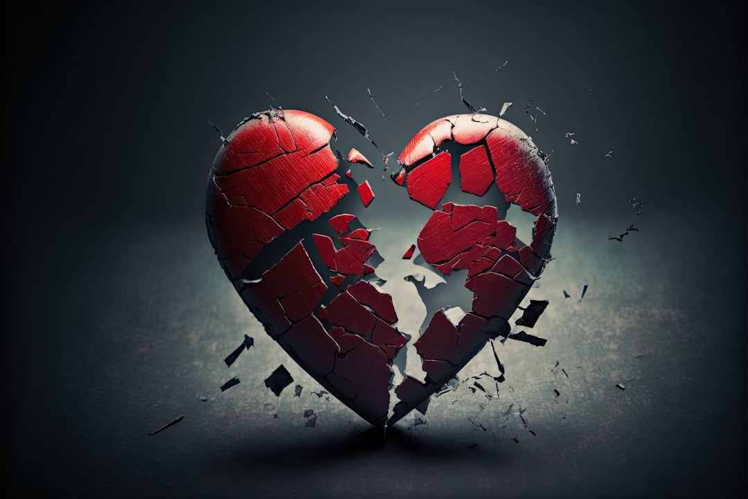 A dark background with a shattered red heart in the foreground