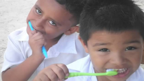 Two children brushing their teeth