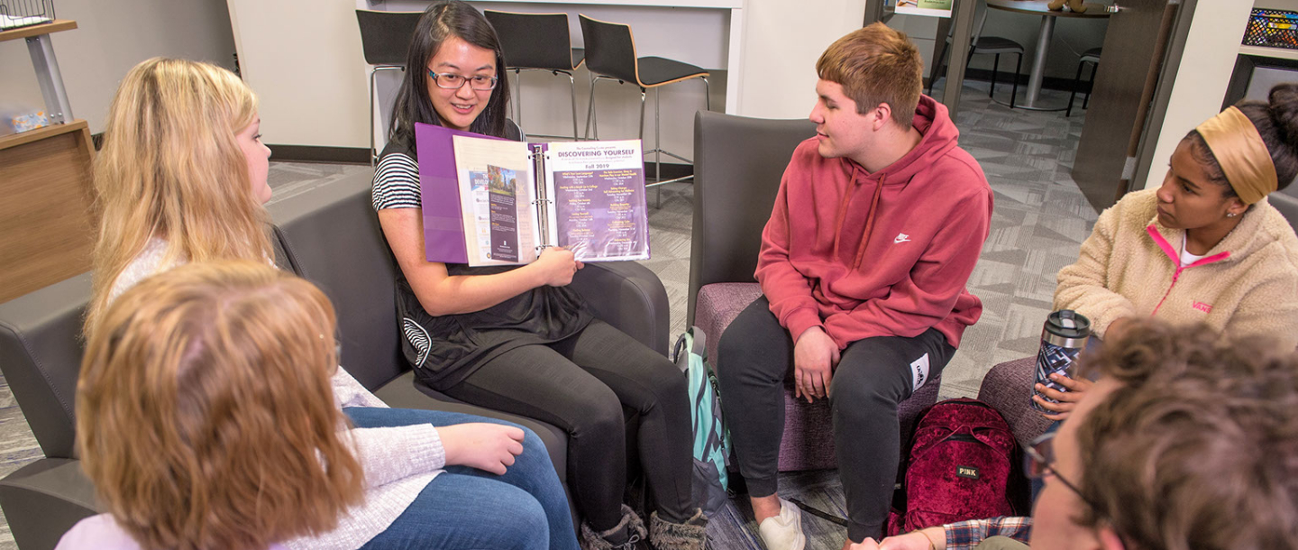 Group of students in a circle with a facilitator showing more information about the program