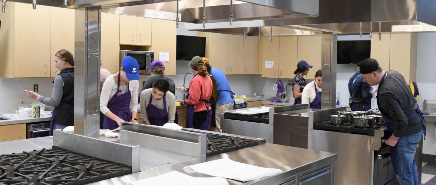 Eleven students of dietetics program working on a food lab