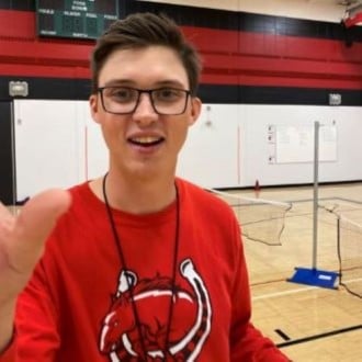 Minnesota State University PE program's alumni student Sam Anderson posing in the gym