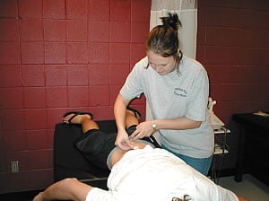 Athletic training student working on person