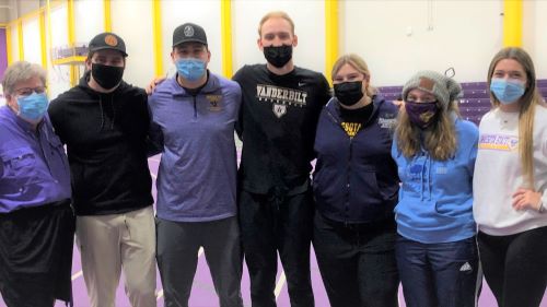 Professor Sue Tarr with PE-DAPE students posing at the 2022 Adapted Floor Hockey event in Myers Field House as part of Hockey Day Minnesota