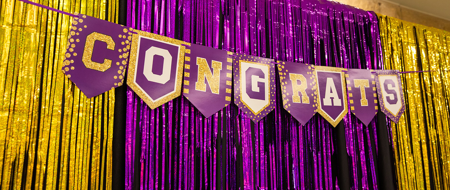 Purple and gold backdrop with "Congrats" banner