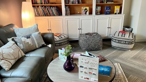 The Equity Engagement space with couch, flexible seating area, table and bookshelf