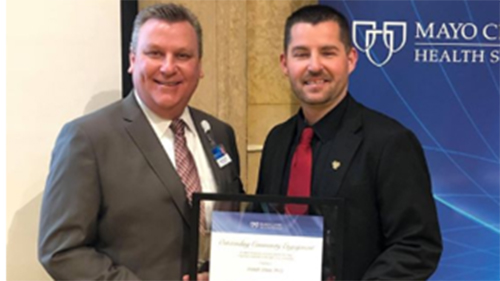 Dr. Joe Visker, a professor in the Department of Health Science, posing with Dr. James Hebl MD, regional vice president of Mayo Health System, after receiving the Outstanding Community Engagement Award