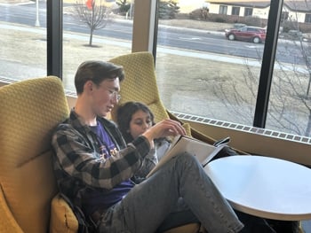 Two people reading in armchairs