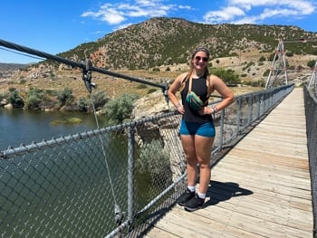 Woman standing on a suspension bridge