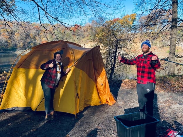 a person and person standing next to a tent