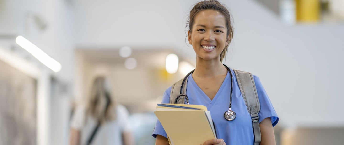 a person in scrubs holding files