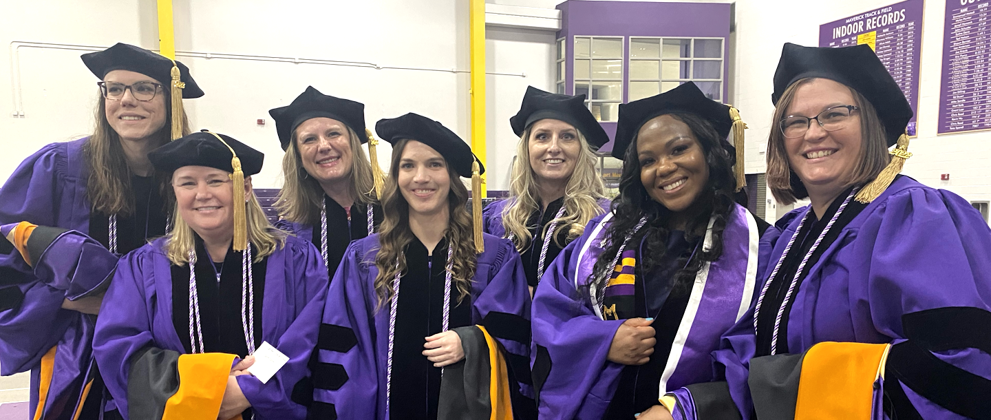 a group of women wearing graduation gowns and caps