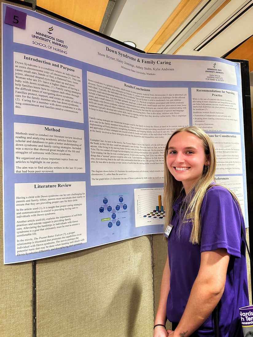 Student with research poster 