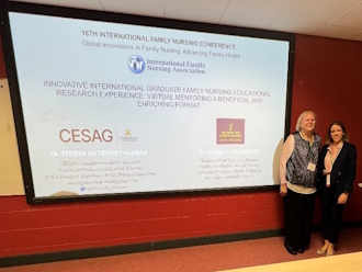 Two people standing in front of a projector screen showing a presentation