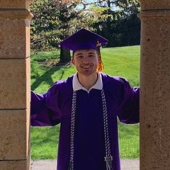 Landon Brown posing in his graduation gown