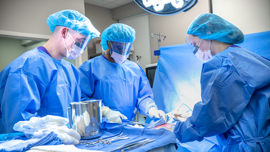 a group of people wearing surgical masks and gloves