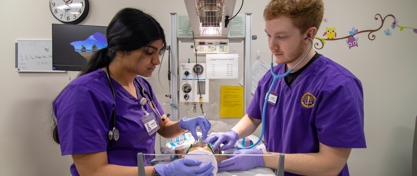 a person and person wearing purple scrubs and gloves