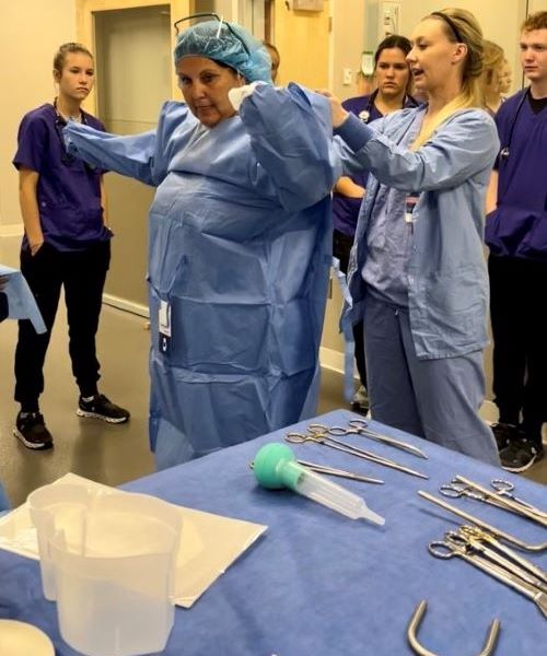 Faculty and students in the Maverick Family Nursing Simulation Center getting ready for a training session