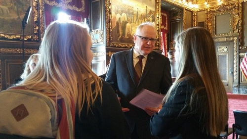 Students speaking with Minnesota governor Tim Walz at the state capital
