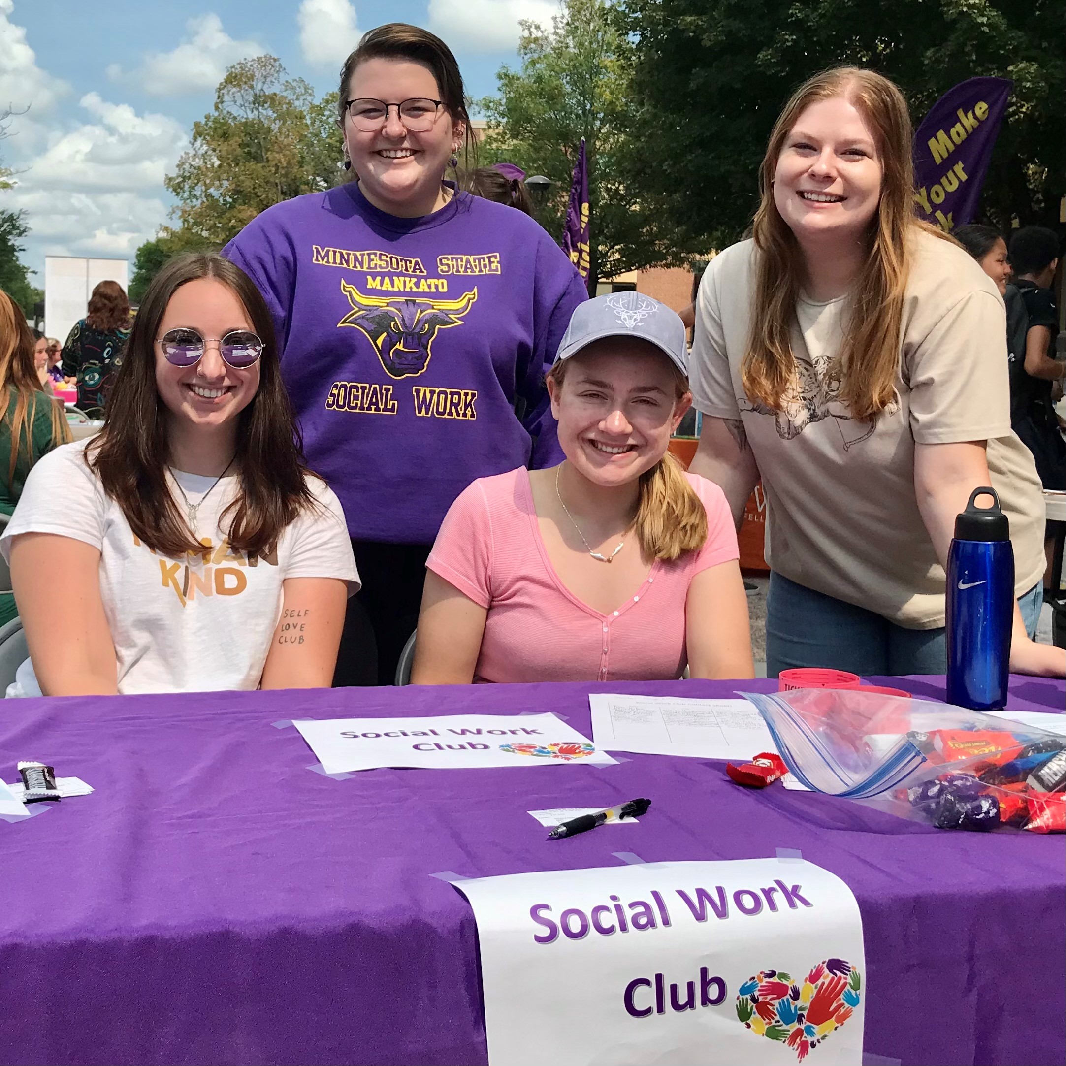 Social work students behind table at activity fair at Minnesota State University Mankato