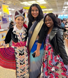 Three women posing for a photo at an event