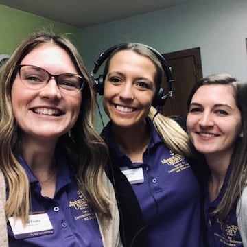 Three women smiling