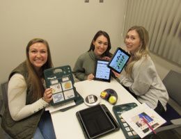 Students working together in the augmentative and alternative communication room