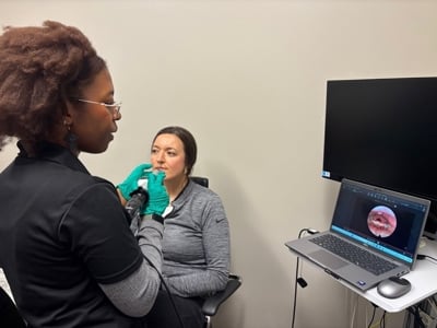 Person performing a swallowing evaluation on another person