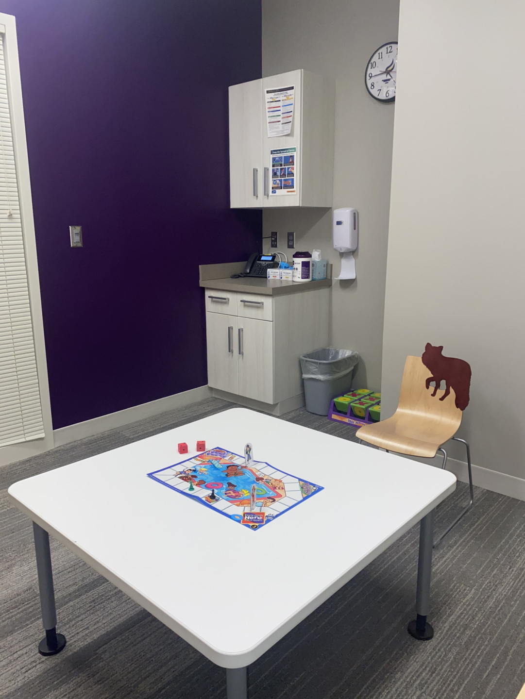 Pediatric therapy room with sink in background and kid friendly table and chair