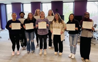 Students holding certificates