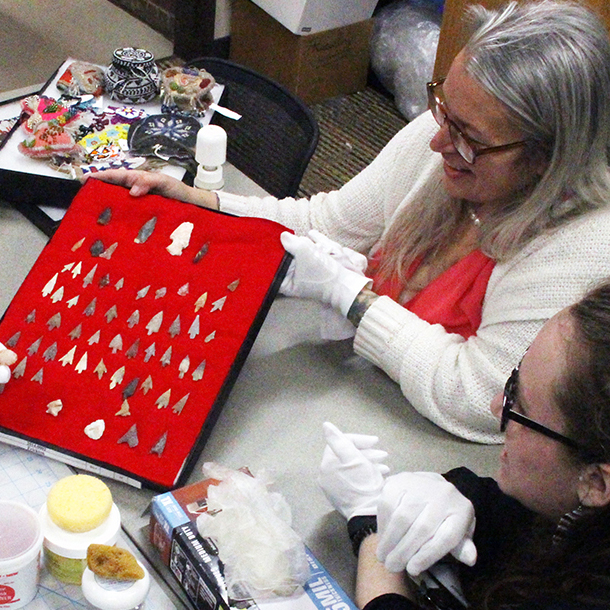 a person looking at a display of pieces of tooth